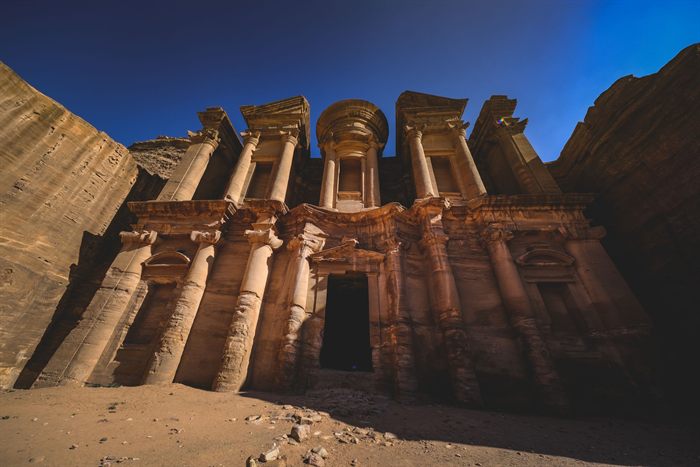 Monastery facade at Petra under a deep blue sky